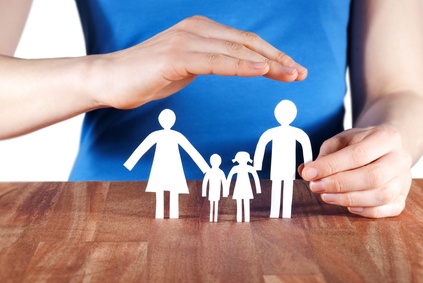 a female hand protecting a paper chain family